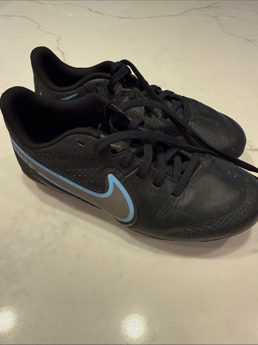 Nike Youth Black Athletic Cleats with Light Blue Swoosh
